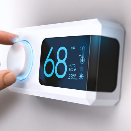 Hand turning a home thermostat knob to set temperature on energy saving mode. fahrenheit units. Composite image between a photography and a 3D background.